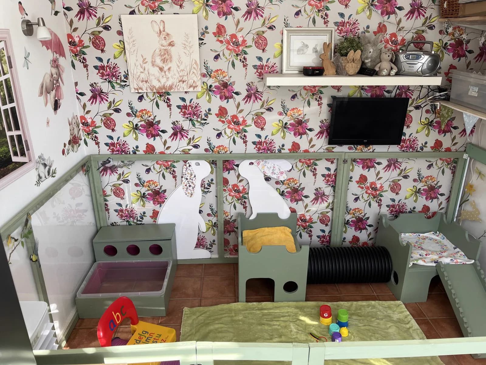 Radio, television and framed rabbit prints on the shelf above the Indoor Bunny Room